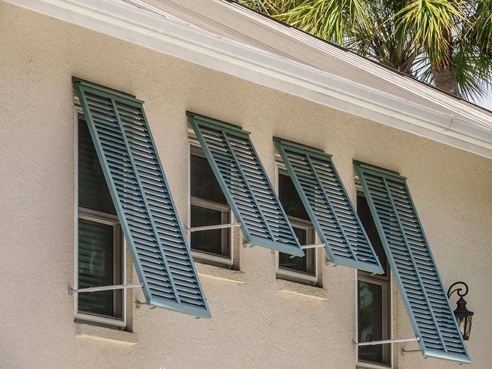 Light Yellow House with blue green Bahama Shutters original